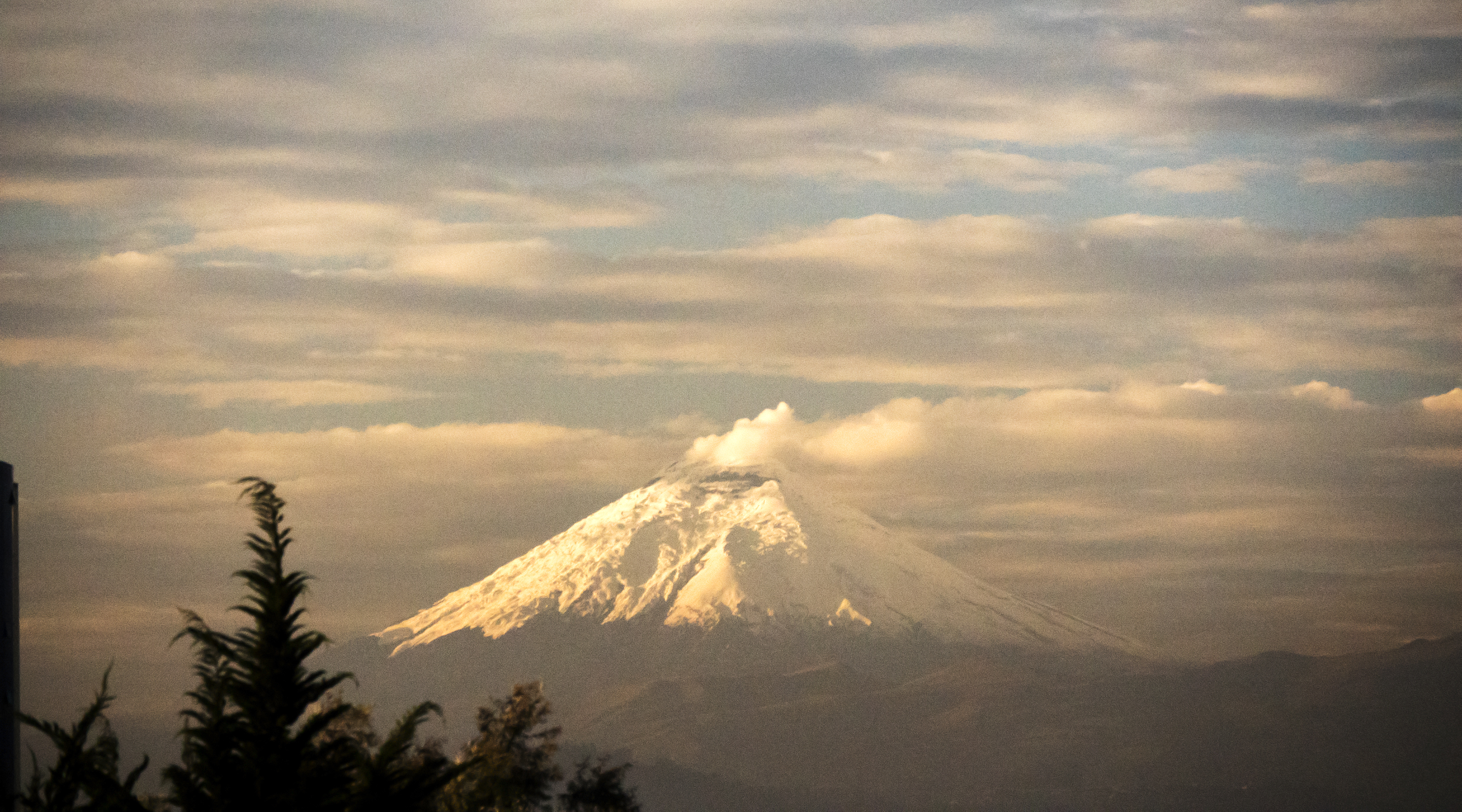 First morning light falls on an erupting Cotopaxi volcano.